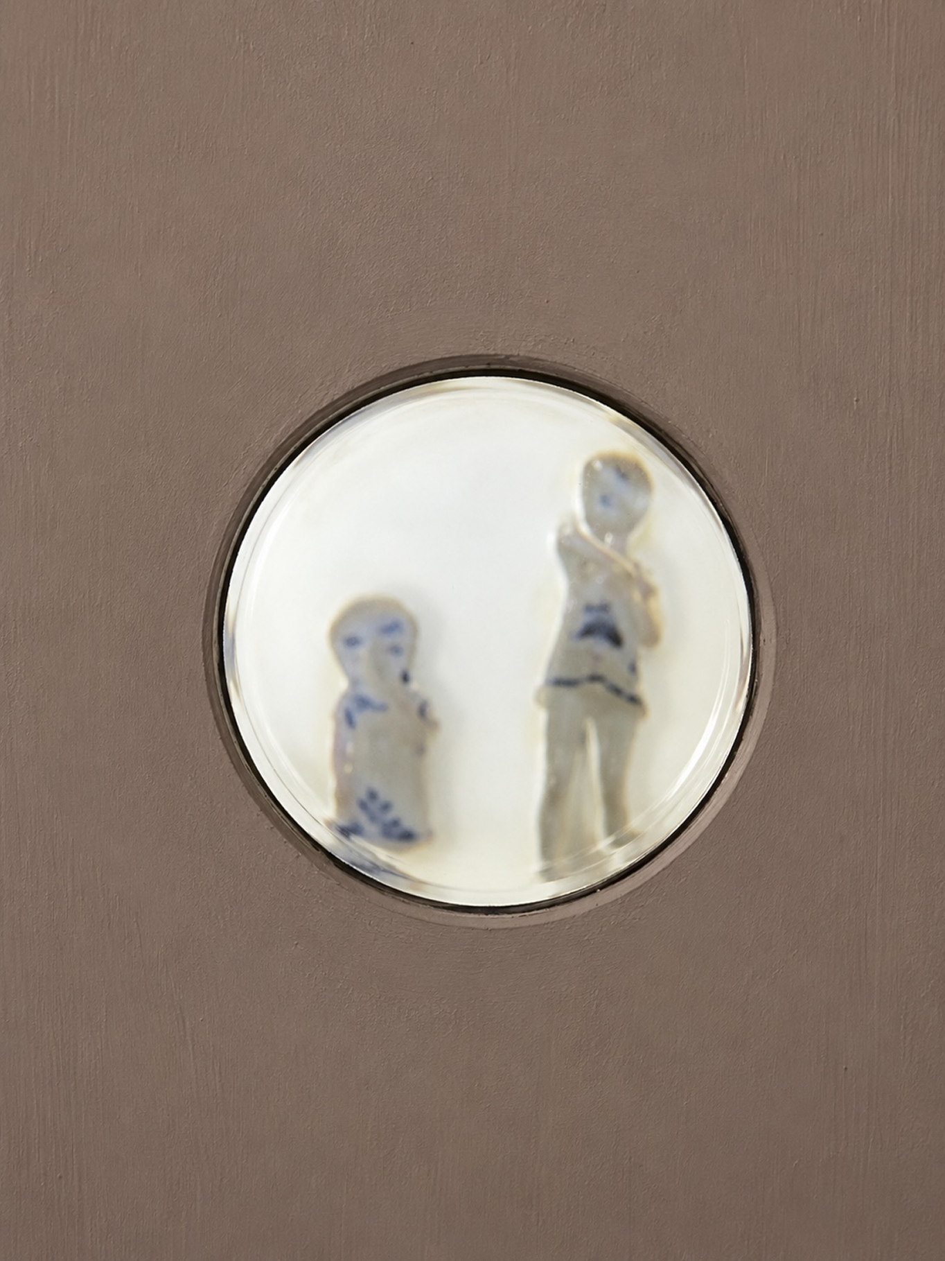 Reflected gallery scene through a circular lens